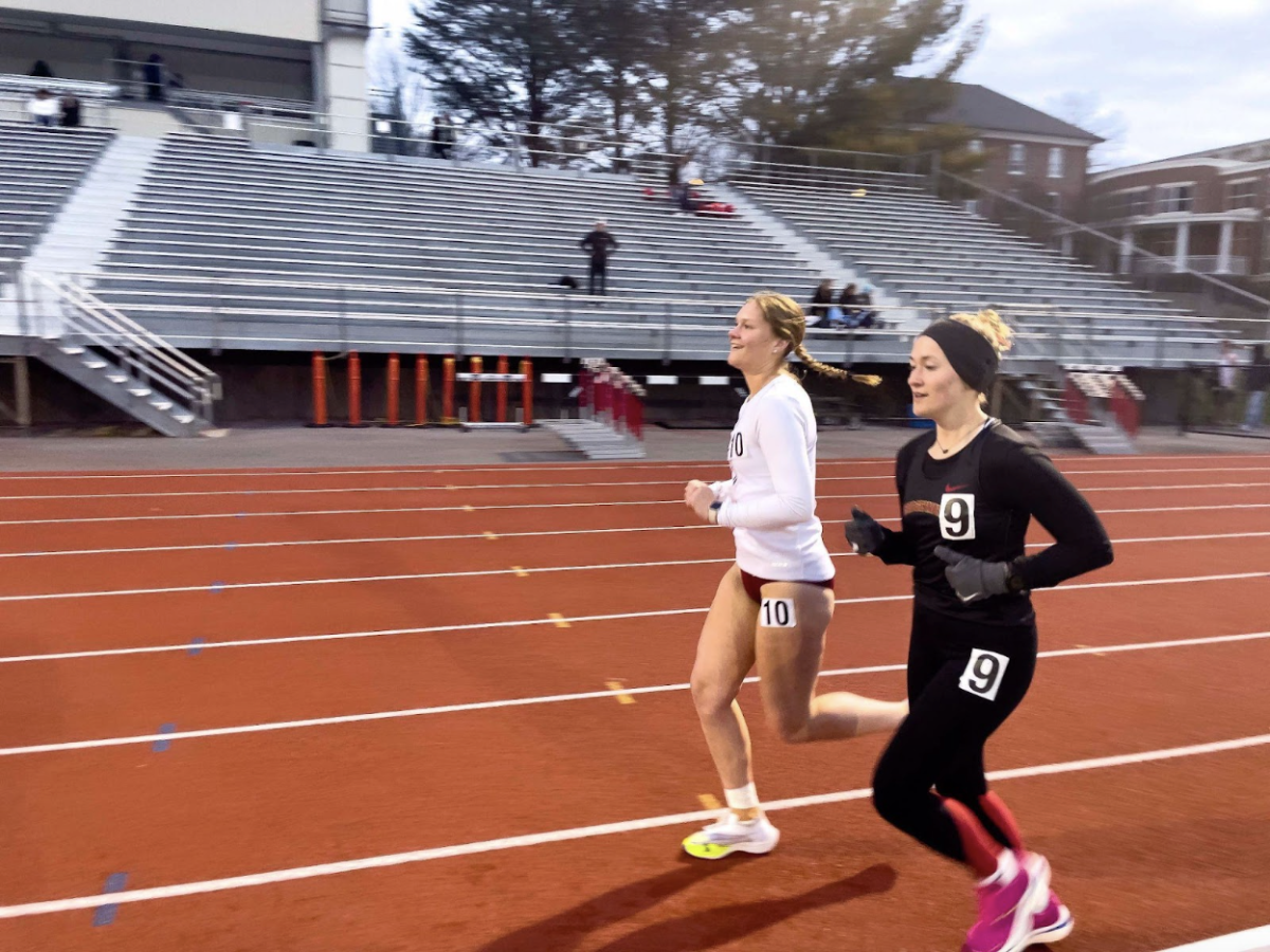 Senior Sarah Earle runs the 5,000 km with help from sophomore Regan Robinson. This was quite the accomplishment for her, since she was the only female runner to take on this race that night.